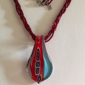 Beaded necklace with glass pendant.